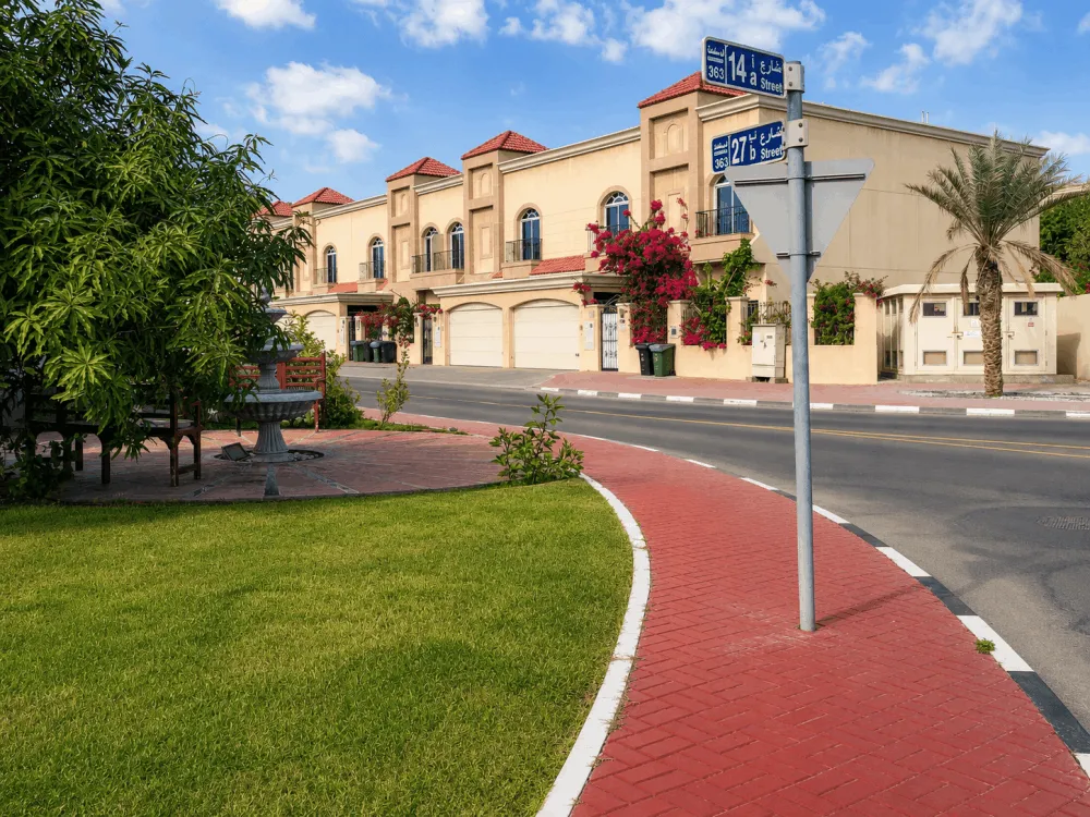 Villas beside a red cycle path on a residential street in Al Manara, Dubai