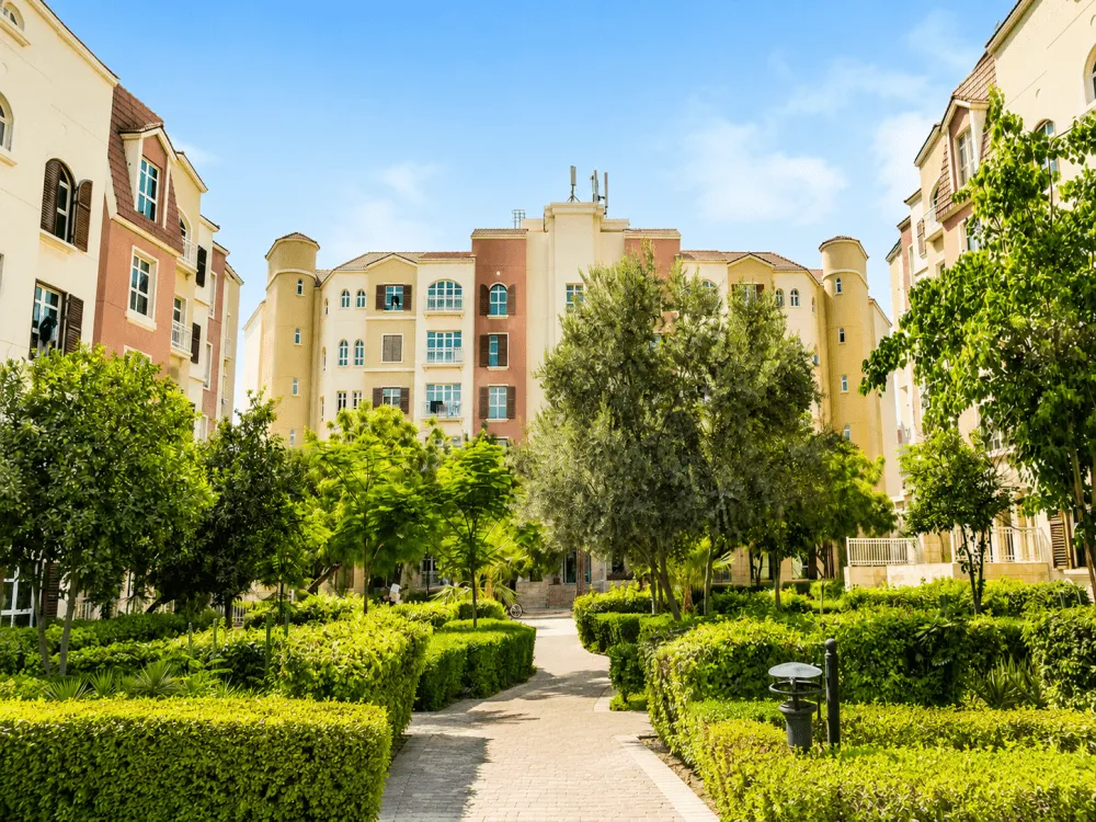 Landscaped courtyard between apartment buildings in Discovery Gardens, Dubai
