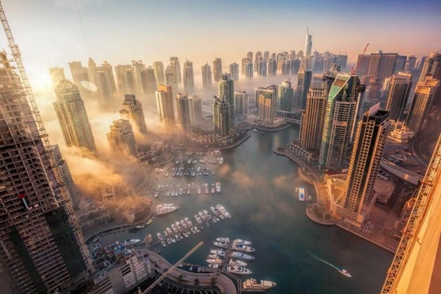 Aerial view of Dubai Marina towers and yacht-filled waterways