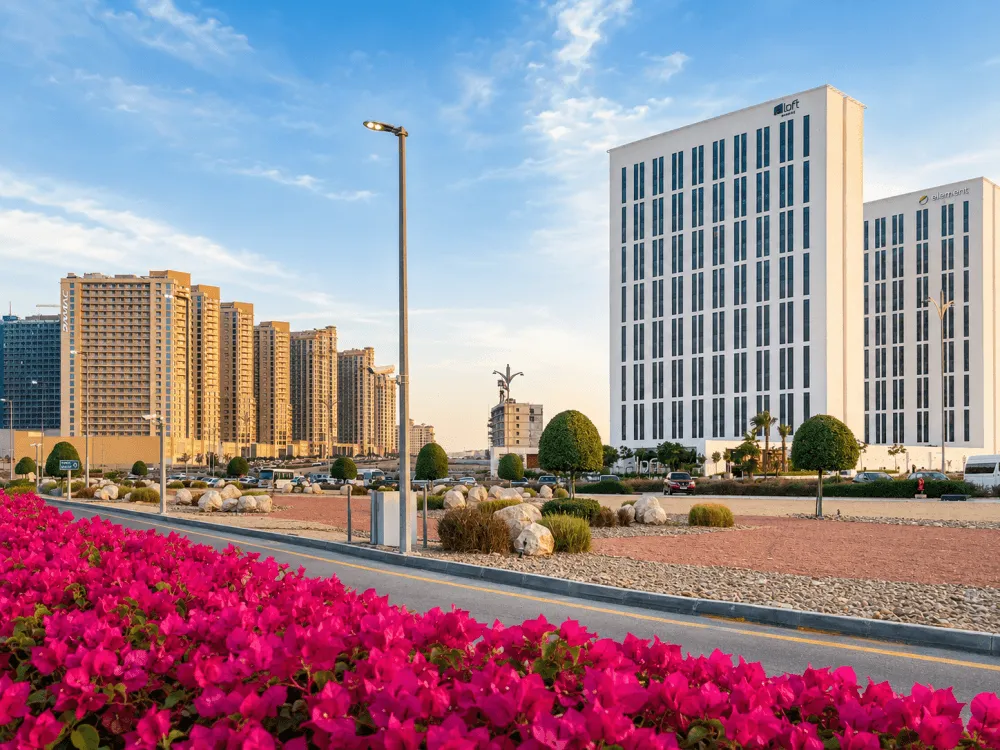 Modern buildings beside landscaped roads in Dubai Production City