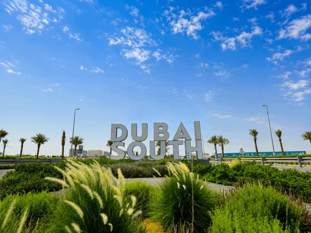 Dubai South landmark sign surrounded by landscaped greenery