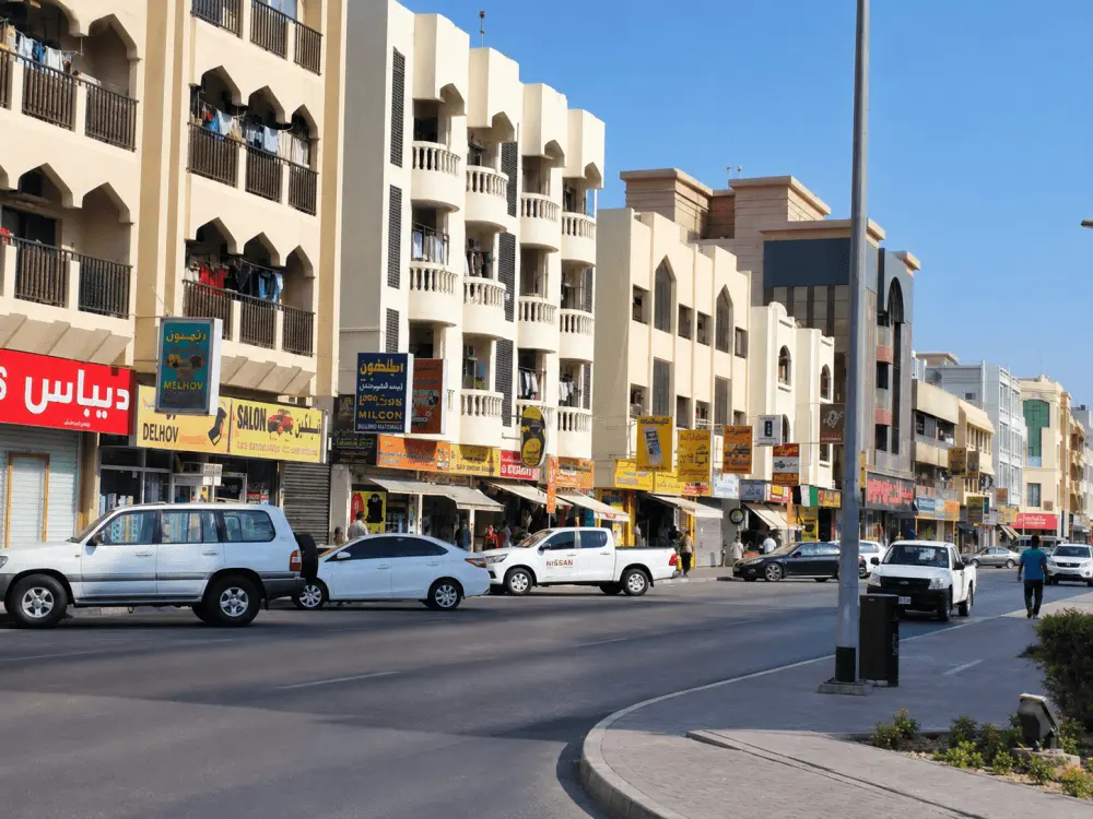 Low-rise shops and apartment buildings along a busy street in Al Satwa, Dubai
