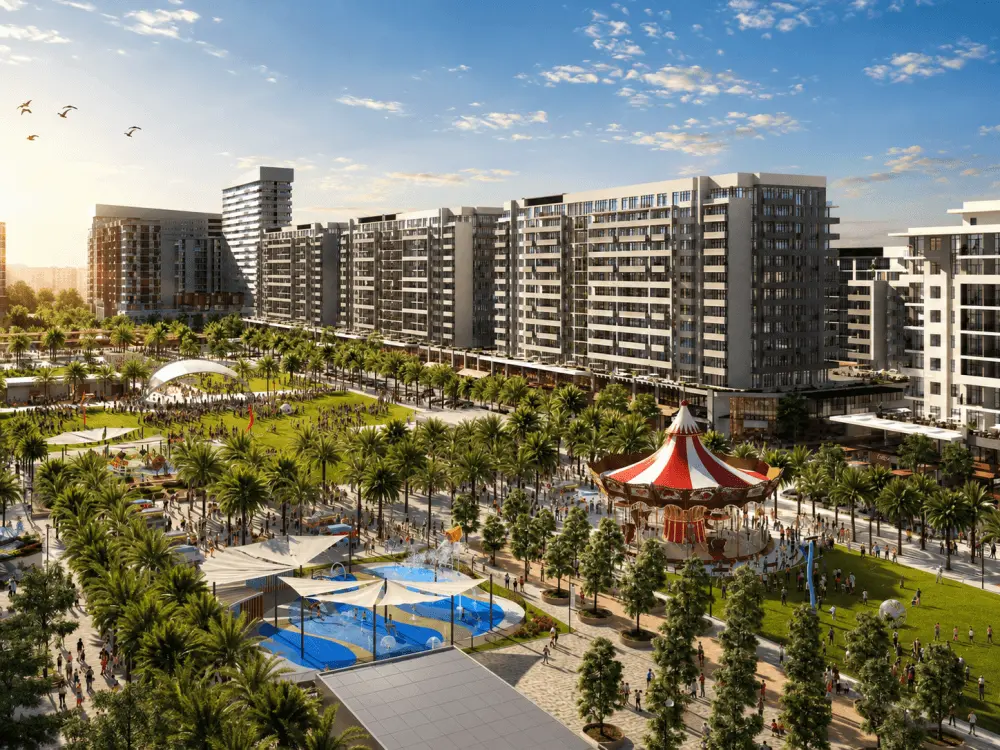 Apartment buildings around a landscaped park and playground in Town Square Dubai