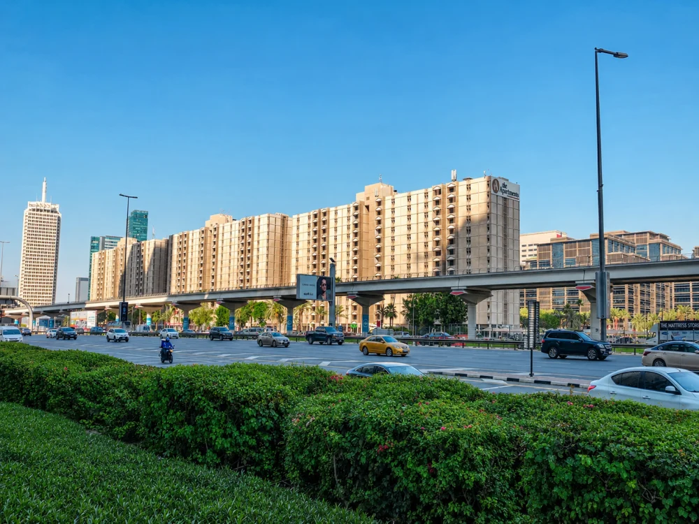 Dubai Trade Centre area with Sheikh Zayed Road traffic, metro viaduct and high-rise buildings.