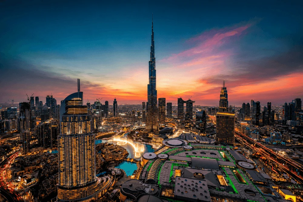 Downtown Dubai skyline at sunset, featuring Burj Khalifa, Dubai Mall and the Dubai Fountain.